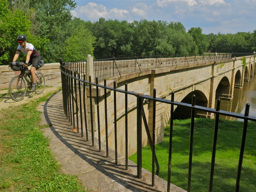 Cycling past an historic canal aqueduct